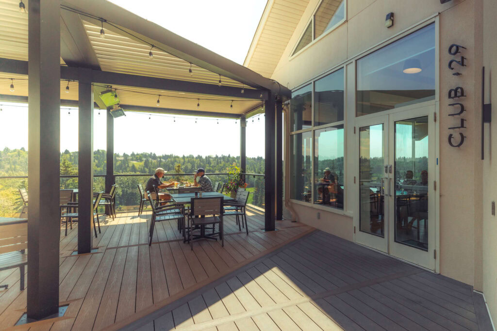Scenic outdoor dining at Highlands Golf Club with panoramic views of the landscape.