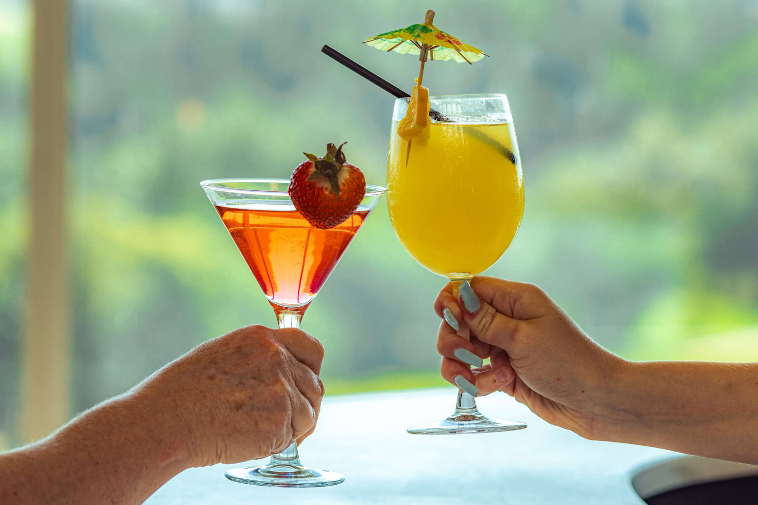 Tropical cocktails at Highlands Golf Club with vibrant drinks and outdoor scenery.