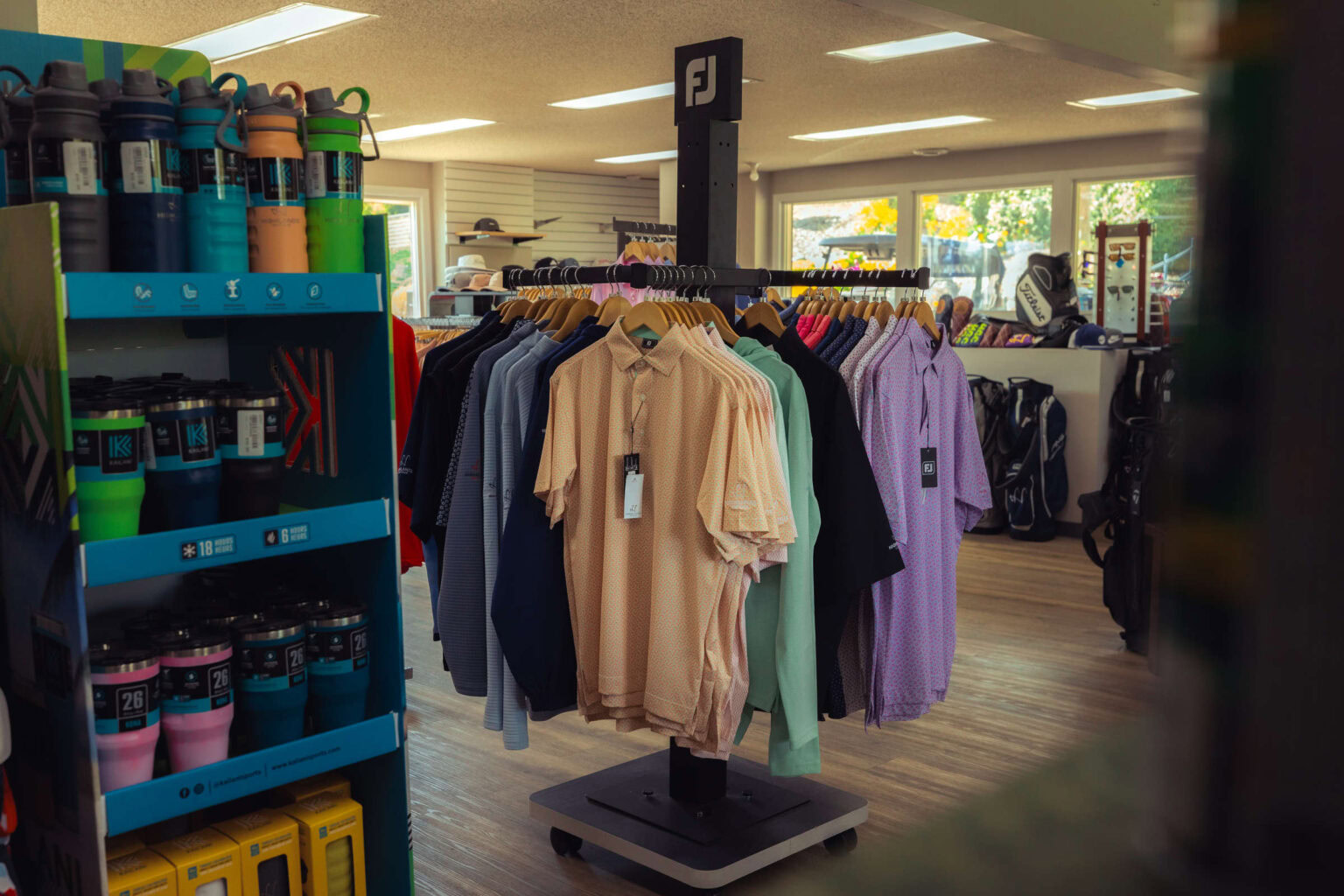 Highlands Golf Club merchandise store with polos and golf accessories.